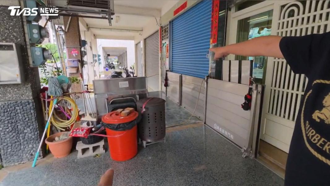 居民架好防水閘門只留一小縫通行,也有人把沙包堆在門口隨時備用。(圖/TVBS)