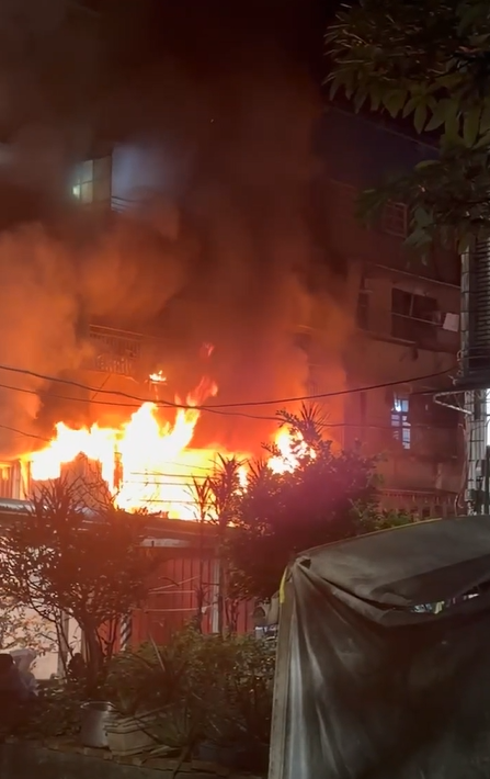 公寓被惡火吞噬，濃煙竄天，警消衝火場救援。（圖／民眾提供）