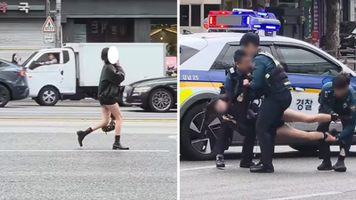 有片/失戀崩潰?黑衣女闖車道講電話大哭 韓警勸不動合力抬走
