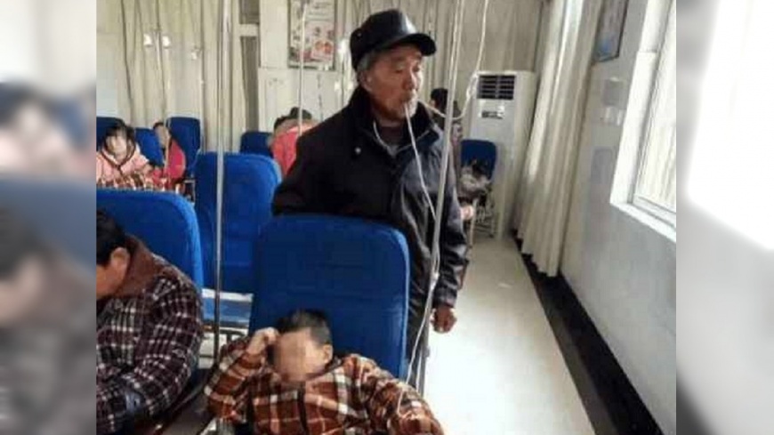 「熱藥爺爺」爆紅!嘴含點滴管線 幫孫暖藥