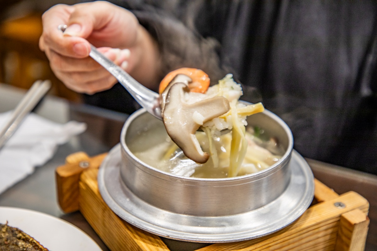 「海產粥」有鮮蝦、蛤蜊、虱目魚肚、香菇等配料,湯頭鮮美。(圖/大手牽小手。玩樂趣 提供)