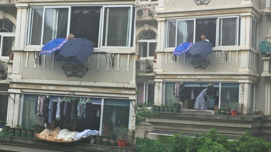 暴雨來不及收衣!樓上阿伯竟「幫撐傘」 網大讚超暖心