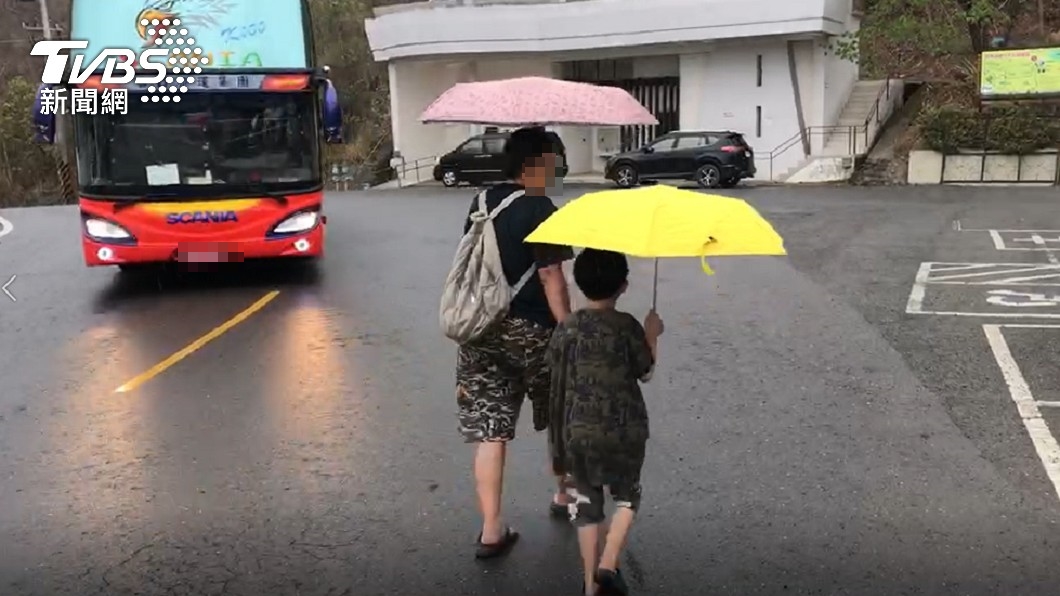 曾文水庫下雨，路人皆撐起傘來。（圖／TVBS）