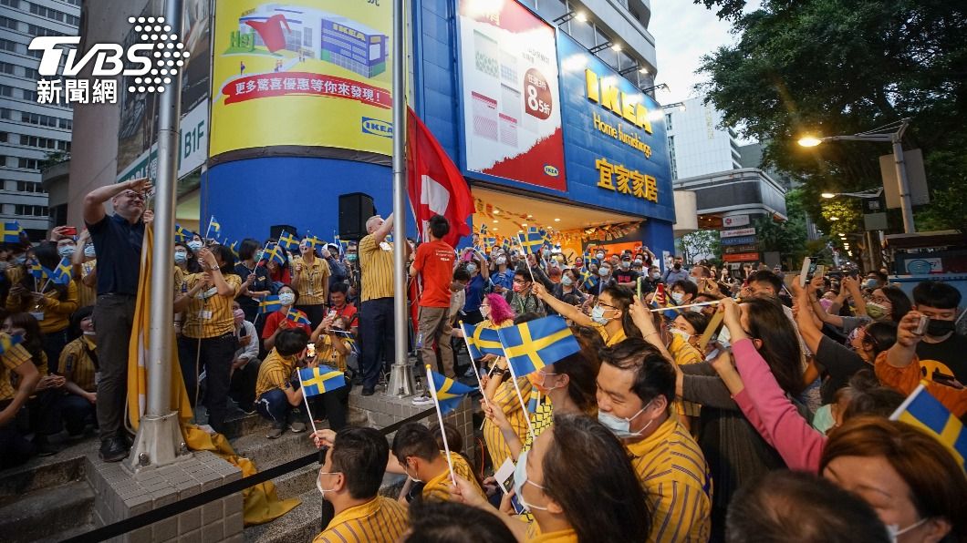 員工傍晚齊聚門口，降下商店旗幟謝幕。（圖／中央社）