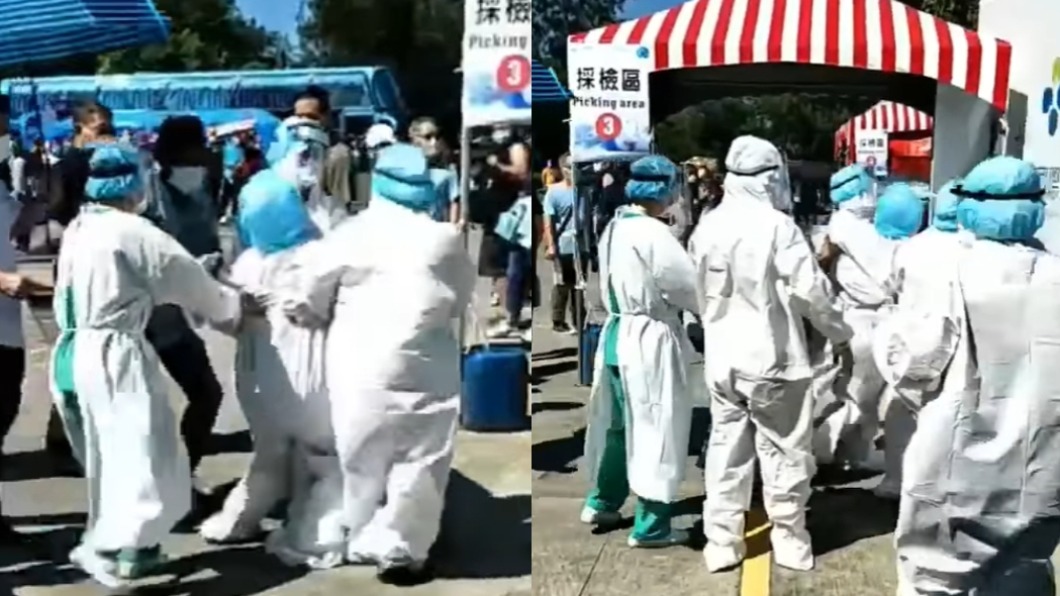 醫護在烈日下穿防護衣篩檢突癱軟。(圖/翻攝自「爆料公社」)