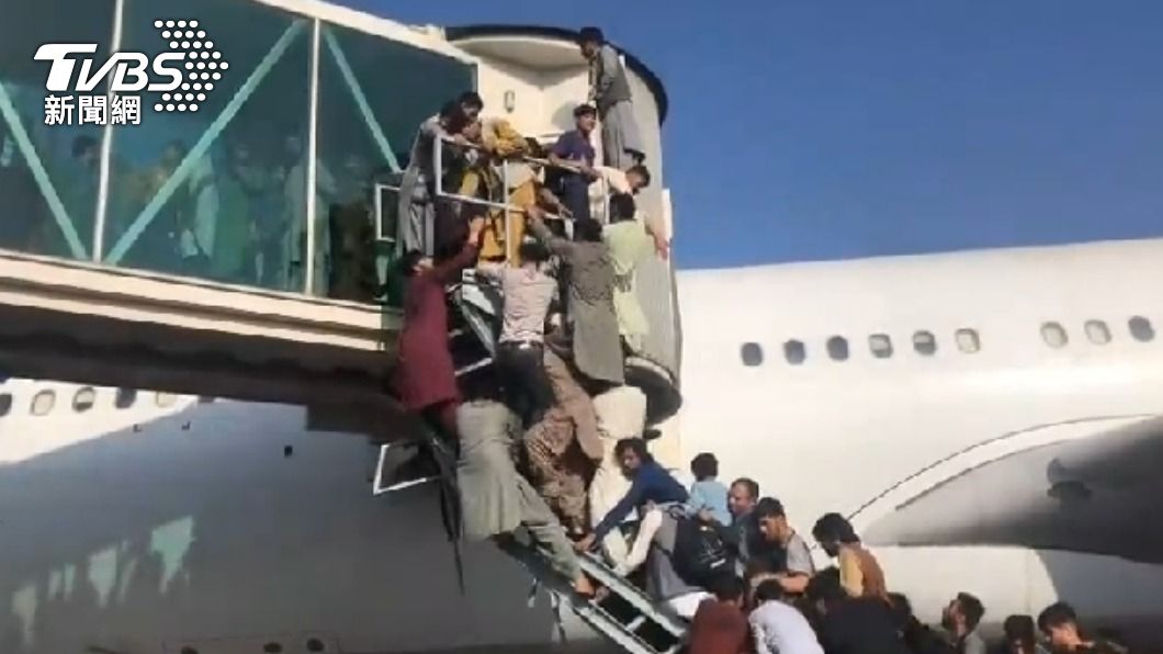 許多民眾為了逃亡,爭相爬上飛機。(圖/CNN提供)