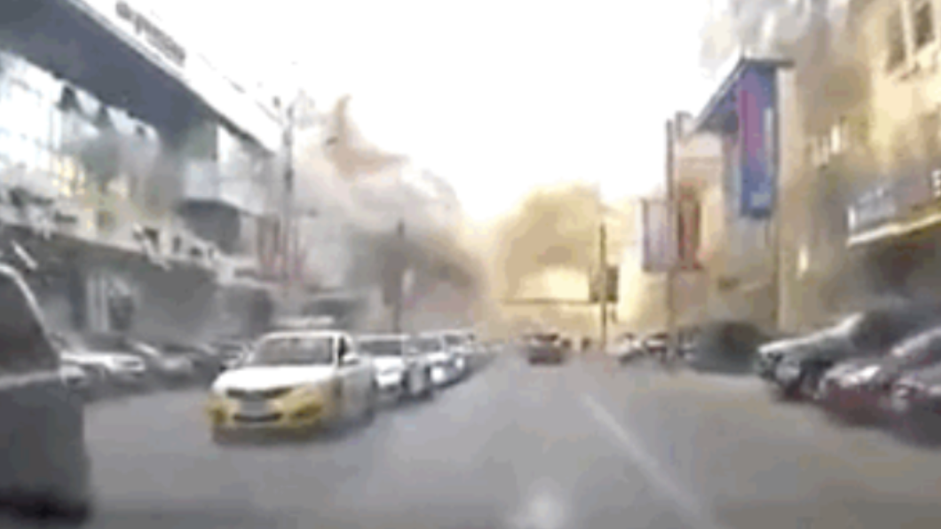 氣爆瞬間,大量濃煙及粉塵自建築物內竄出。(圖/翻攝自央视新闻 微博)