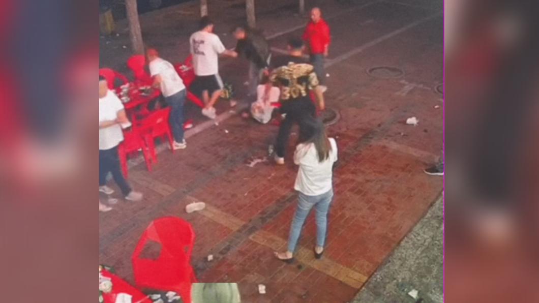 男子持酒瓶攻擊女子頭部。(圖/翻攝自微博)