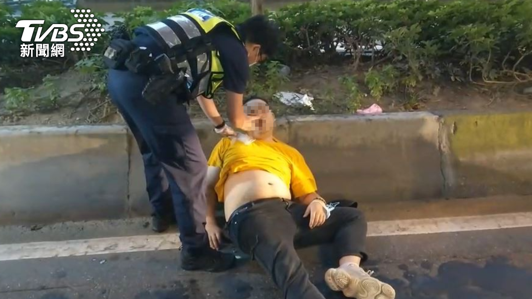 員警以手靠近口鼻，確認男子是否還有呼吸。（圖／TVBS）