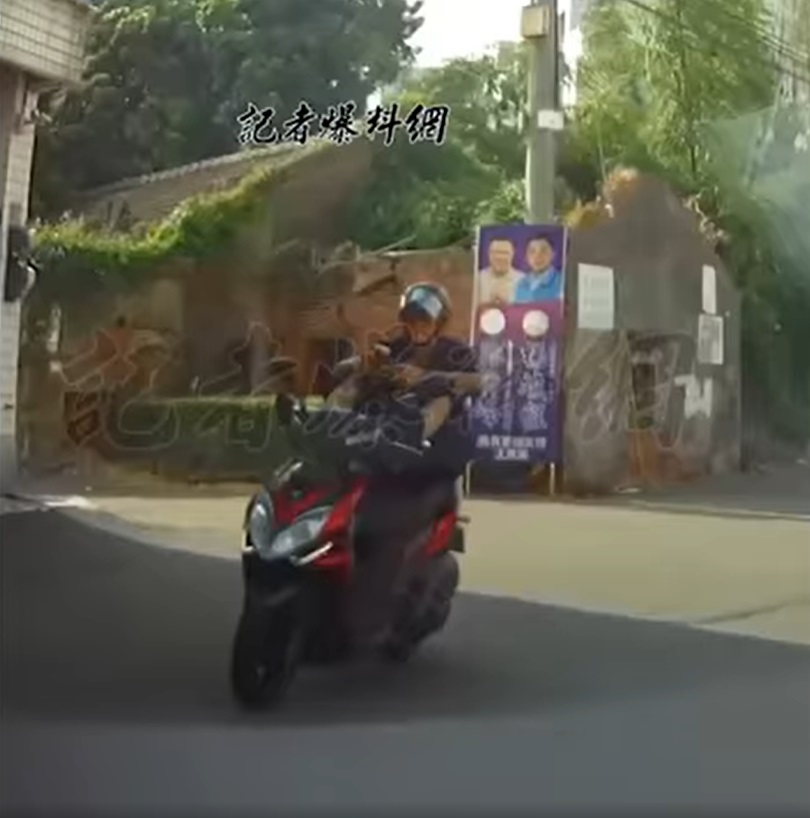 仔細一看騎士竟是用雙腳控制龍頭和油門雙手則是滑手機。(圖/翻攝自臉書社團「記者爆料網」)