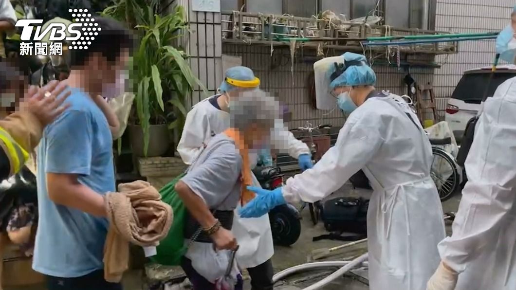 消防人員利用共生面罩將年邁住戶帶下樓。(圖/TVBS)