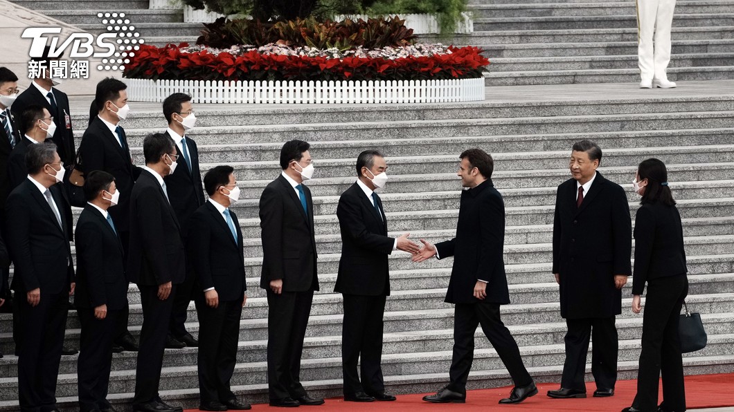 中共中央外事辦主任王毅在與法國總統外事顧問通話時,讚揚法國總統馬克宏「體現獨立自主」。圖為2023年4月6日在北京人民大會堂歡迎儀式上,馬克宏與王毅握手。(圖/達志影像美聯社)