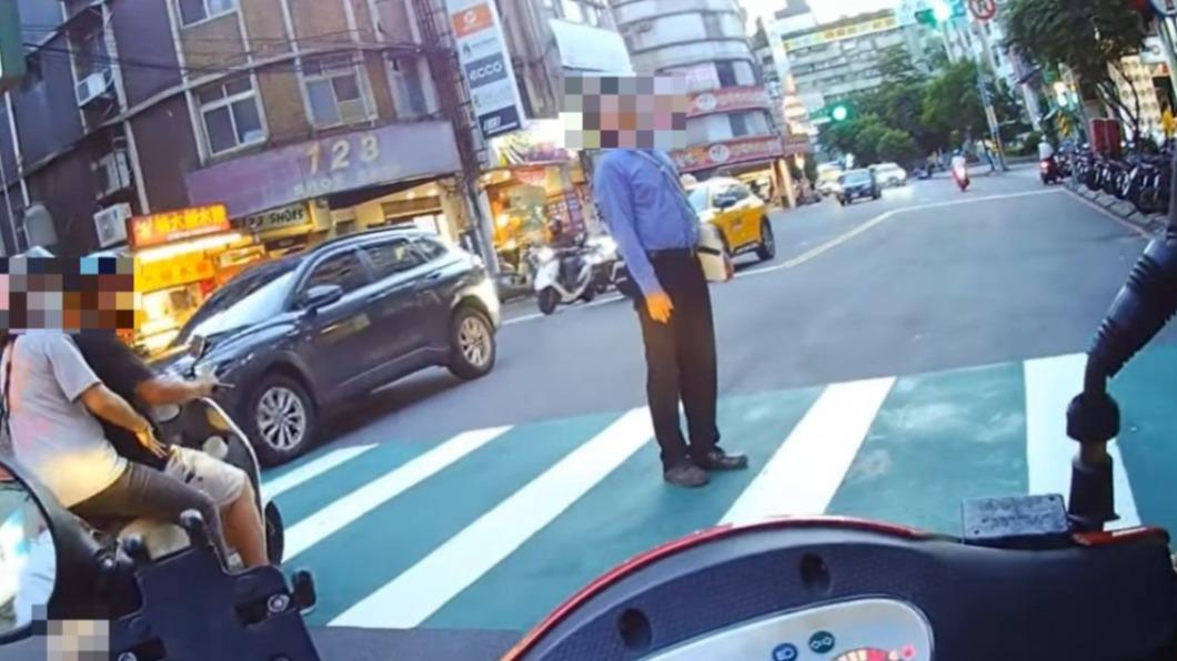 男子在過馬路時突然無視紅燈,大剌剌停在斑馬線上看天空發呆。(圖/翻攝自「我是永和人」臉書)