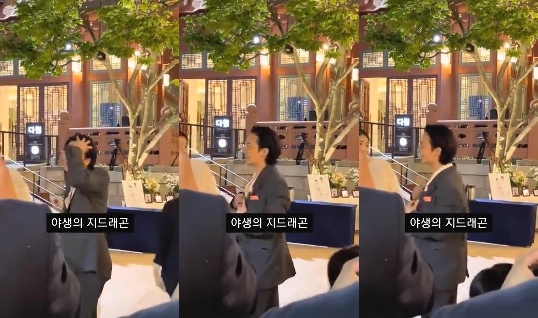 參加婚禮時,GD被拍到動個不停。(圖/翻攝自Tyubi1218推特)