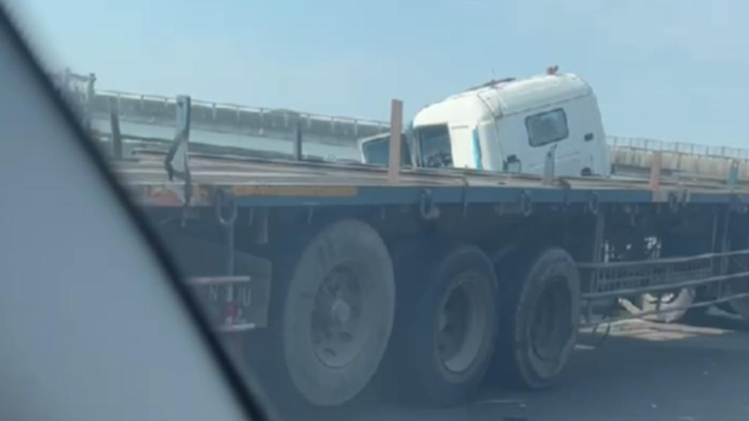 聯結車因不明原因撞破護欄，險些衝到隔壁車道上。（圖／翻攝自記者爆料網）