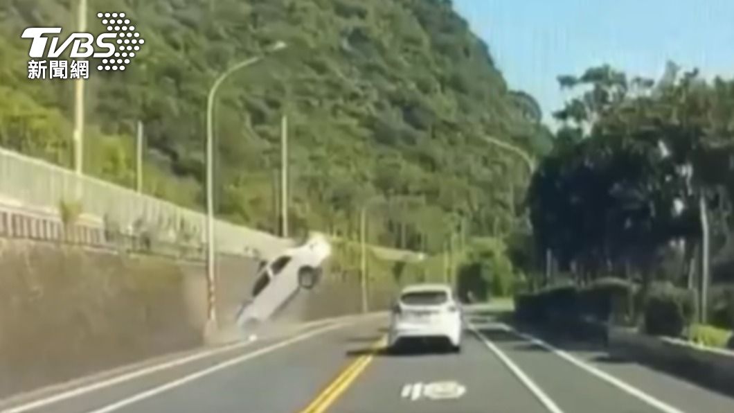 白車撞向燈桿造成車尾翹起。(圖/TVBS)