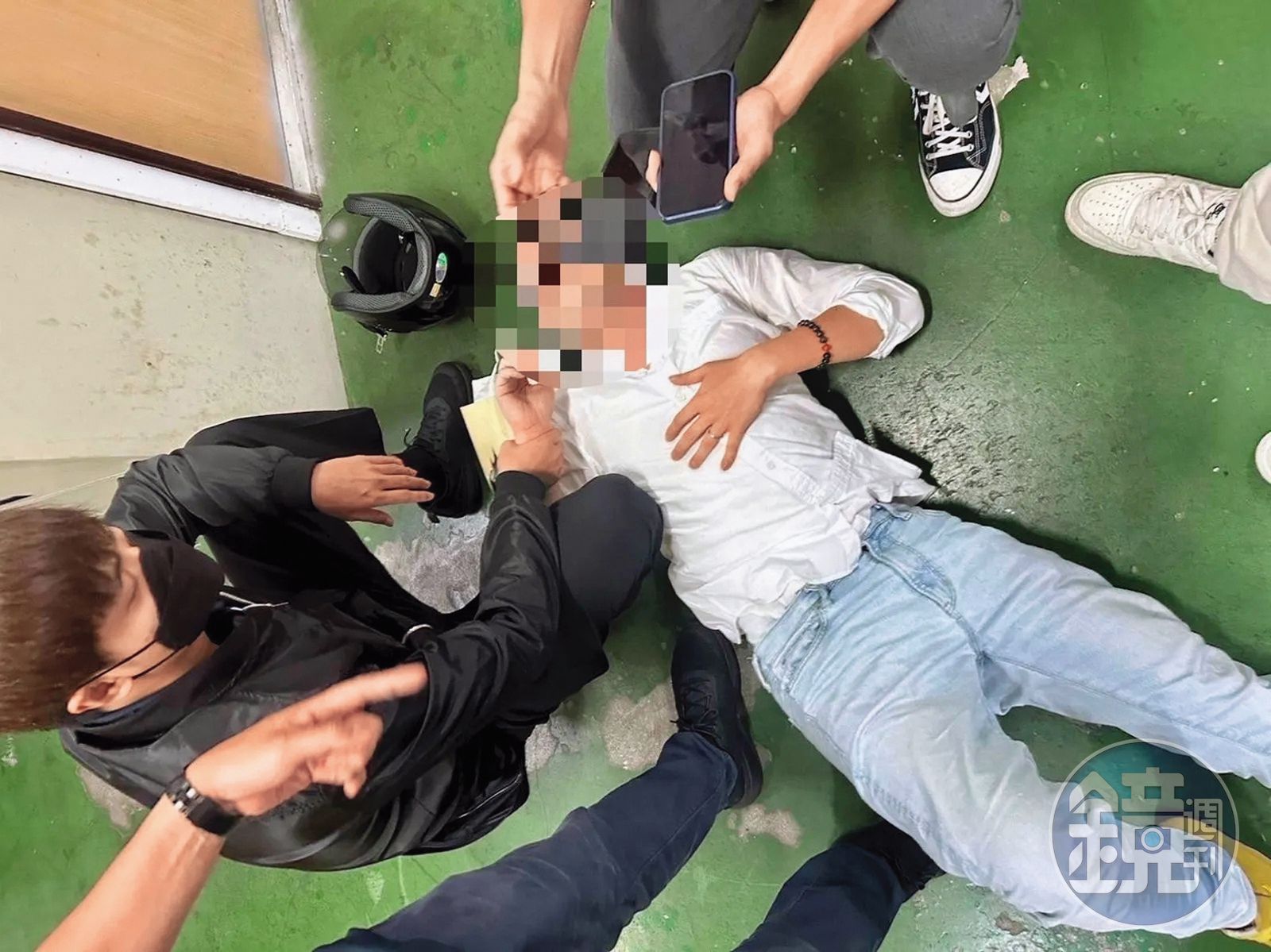 陳鑒在新北板橋火車站遭警方壓制在地，畫面狼狽。（圖／鏡週刊，讀者提供）