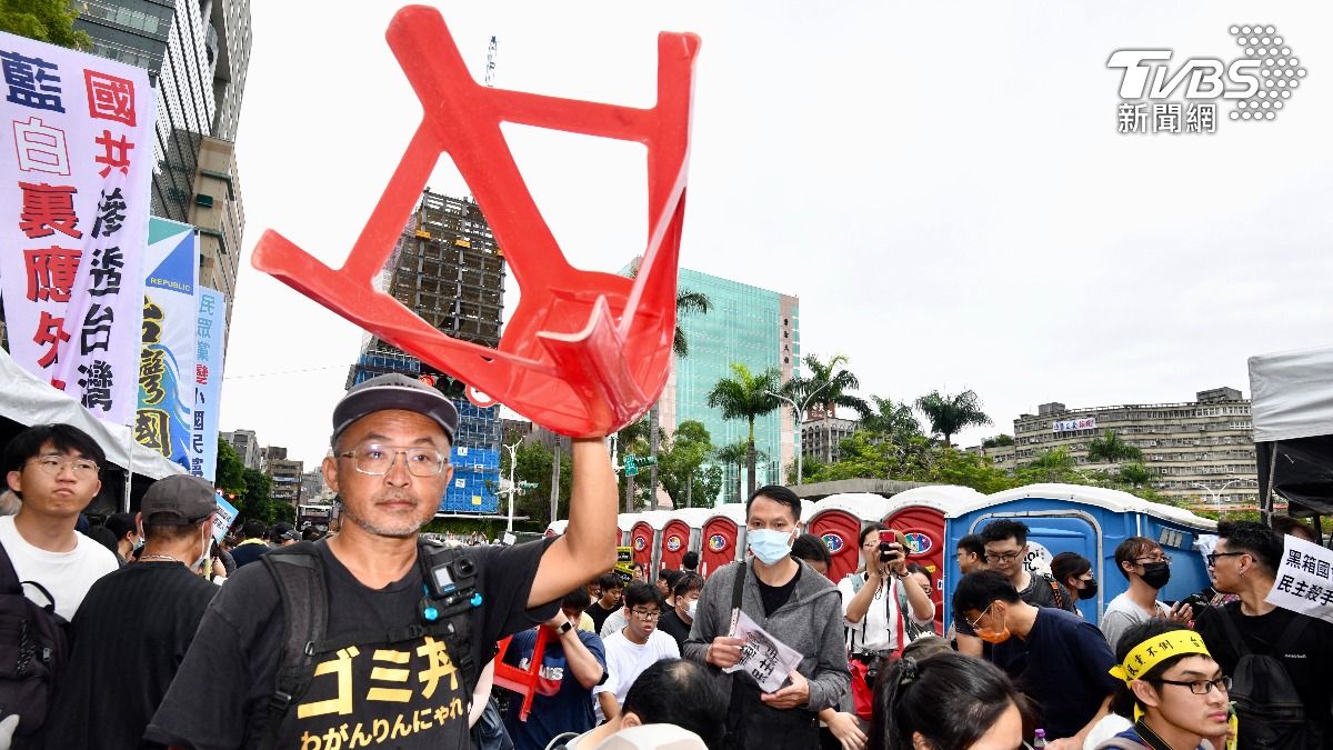 現場民眾舉起椅子。（圖／胡瑞麒攝）