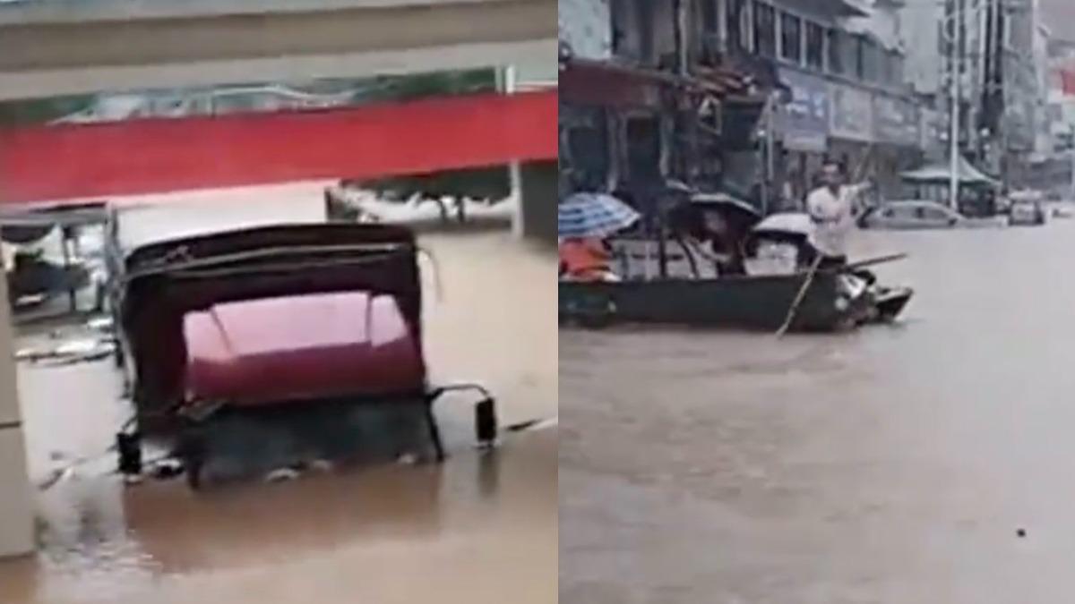 湖南車輛被滅頂,居民划船出門。(圖/翻攝自 微博)