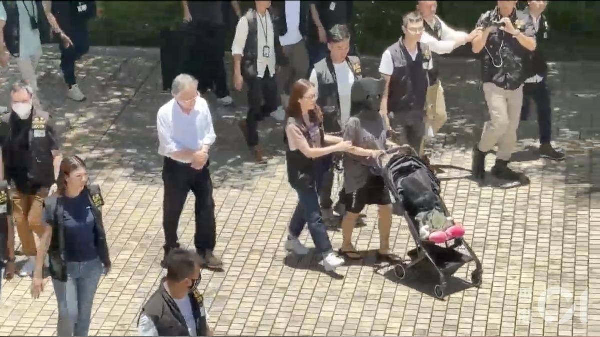 嫌犯推著裝有人形道具的嬰兒車幫助重組案情。（圖／香港01）