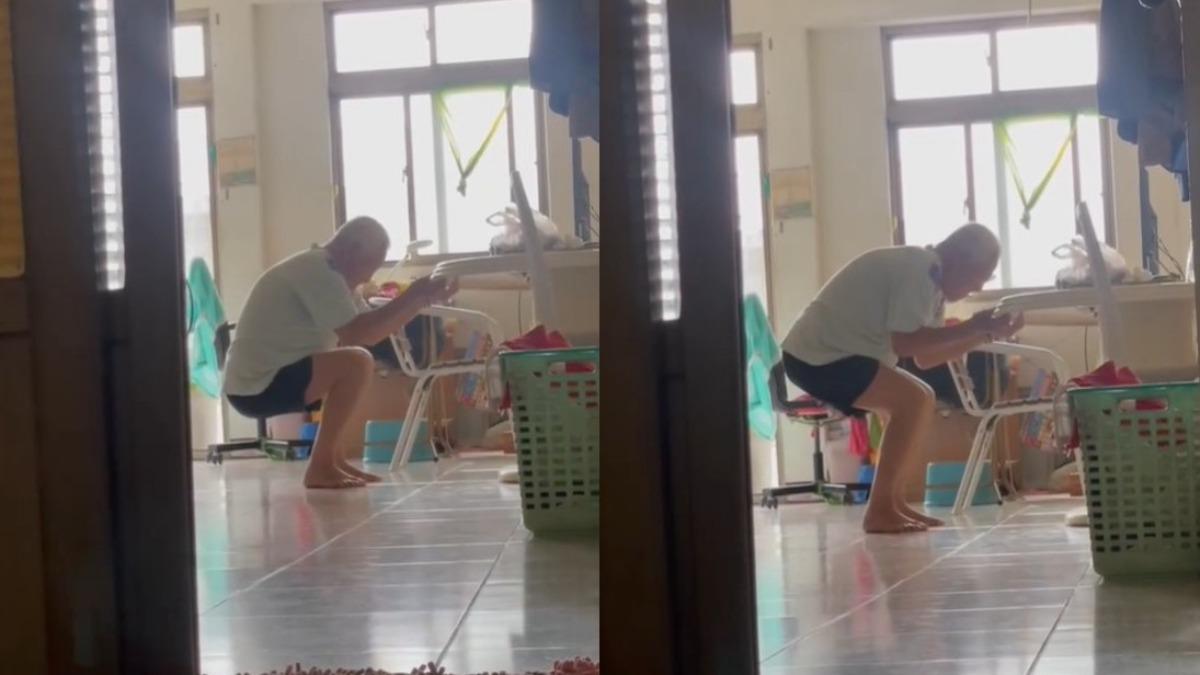 近百齡人瑞的阿公,扶著桌子深蹲運動。(圖/翻攝自蔡允潔臉書粉專)