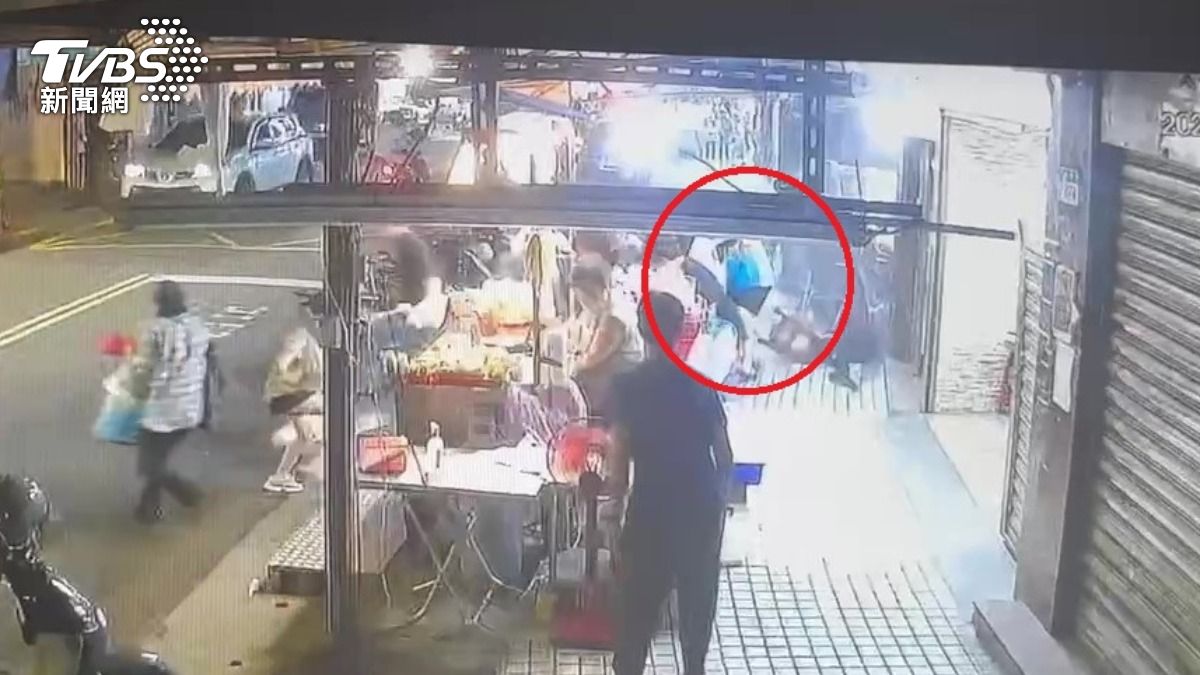 車輛撞上攤位時，藍衣男子幸運逃過一劫。（圖／翻攝畫面）