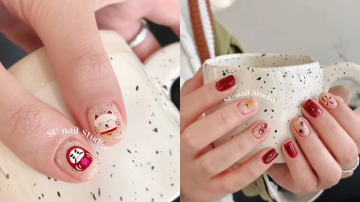 紅色煙花、貓掌和迷你達摩圖案完美結合。（圖／翻攝自小紅書@SU Nail Studio）