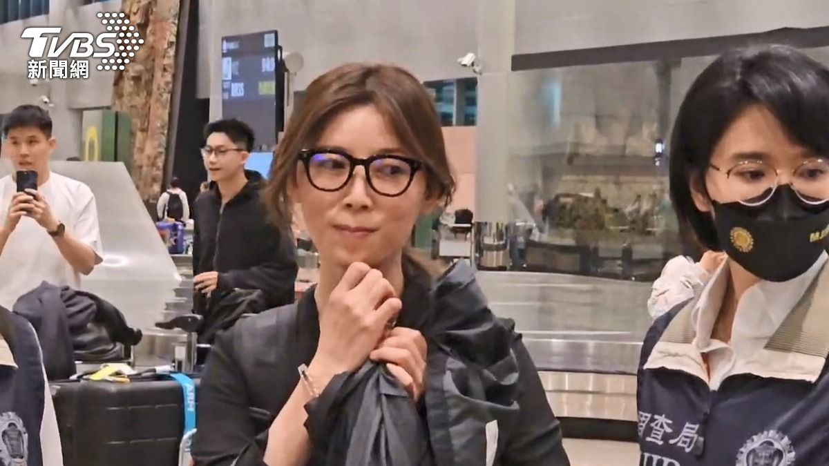 貴婦奈奈在一旁看著調查局人員幫忙搬行李。（圖／TVBS）