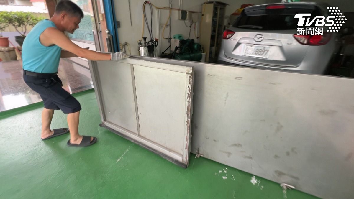 丹娜絲颱風持續靠近南台灣，就怕又發生去年颱風淹水慘況，高雄仁武住戶提早裝設防水閘門，準備沙包。（圖／TVBS）