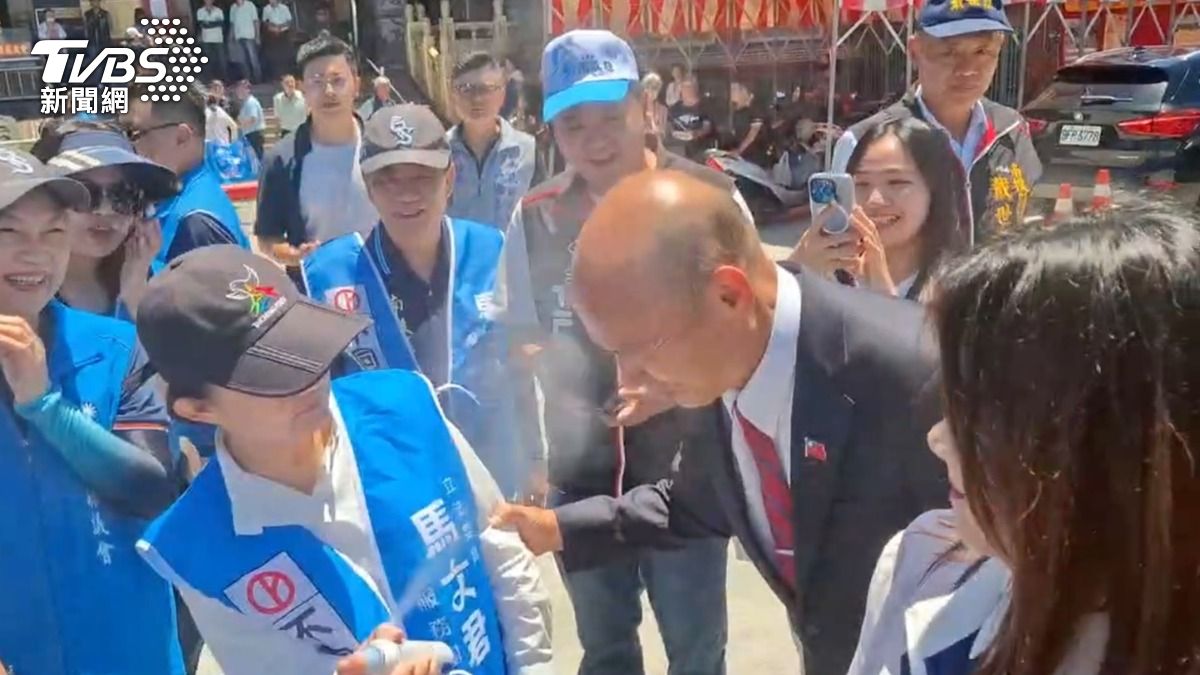 韓國瑜同樣被防曬噴霧吸引,不但噴了臉部,還不忘後腦杓也請盧秀燕補噴。(圖/TVBS)
