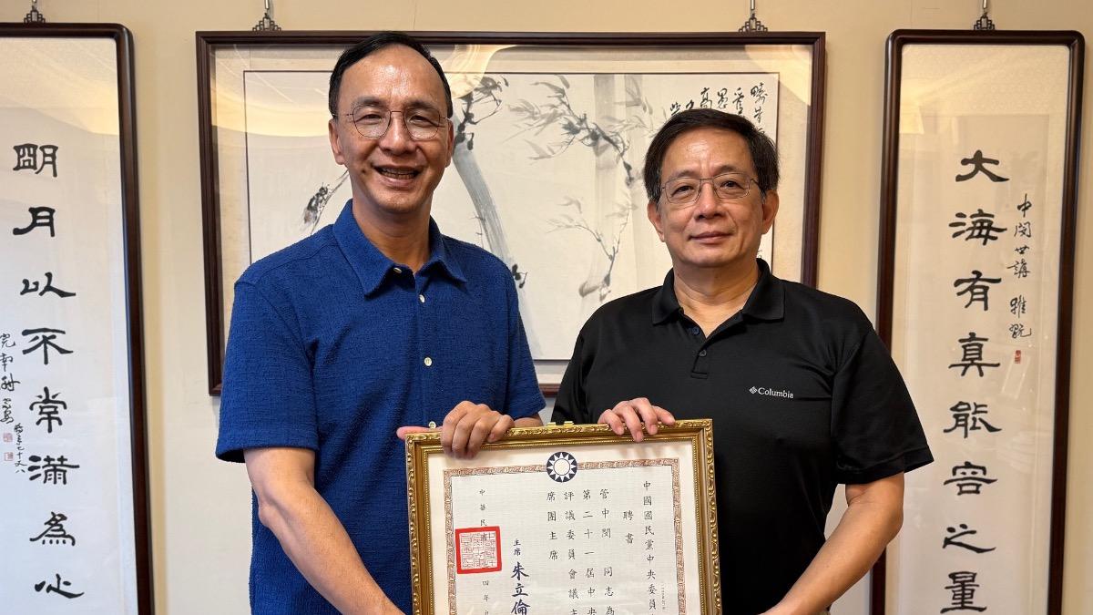 國民黨主席朱立倫頒發中評委聘書給台大前校長管中閔。(圖/國民黨提供)