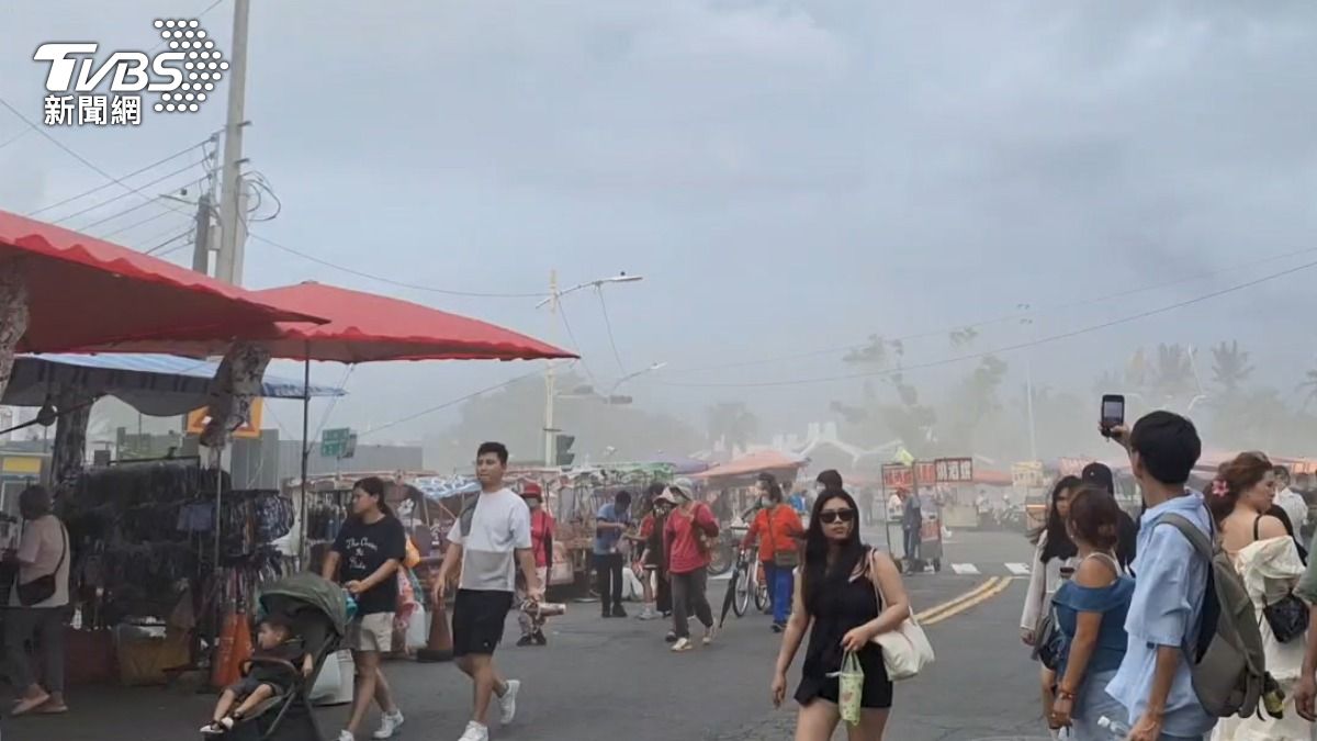 遊客和攤販都被這罕見奇景吸引，紛紛拿出手機記錄下這一幕。（圖／TVBS）