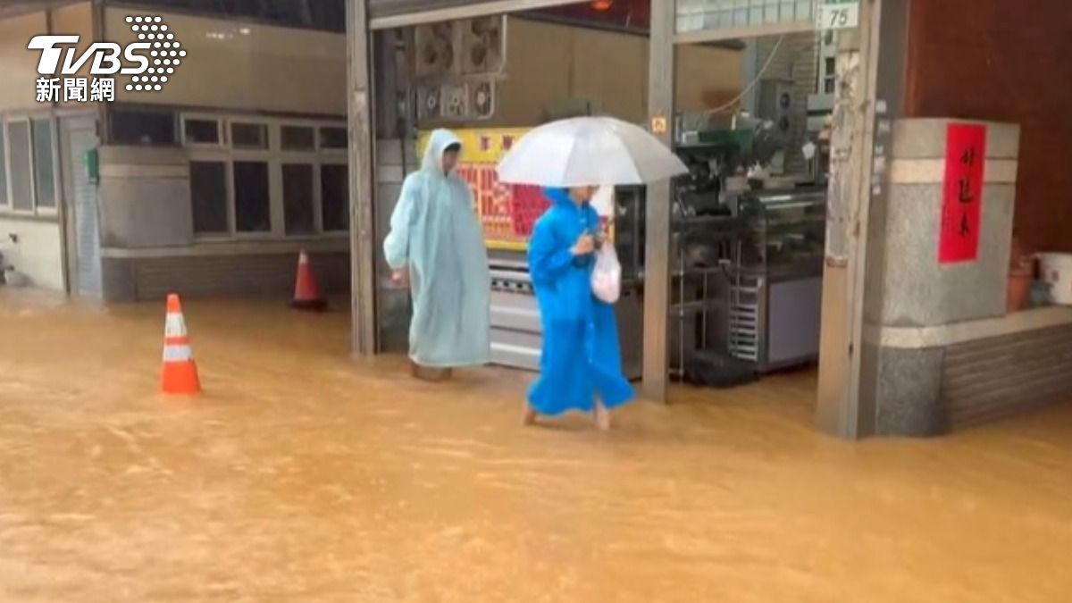 雨勢猛烈，民眾穿雨衣、撐傘雙重防水。（圖／TVBS）