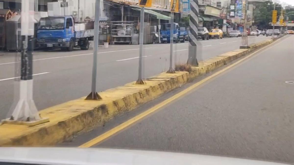 朋友上前勸阻兩人一言不合就打起來，兩人趴在分隔島上。(圖／TVBS) 