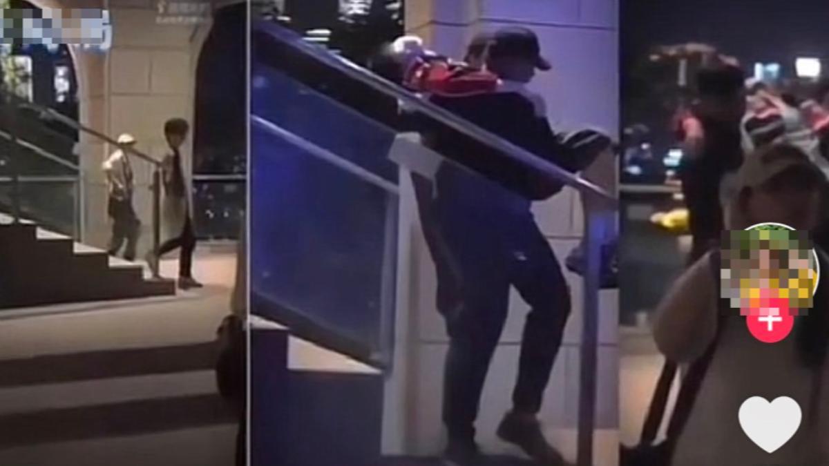 疑似于朦朧被黑衣男抬下樓。(圖/翻攝自TikTok)
