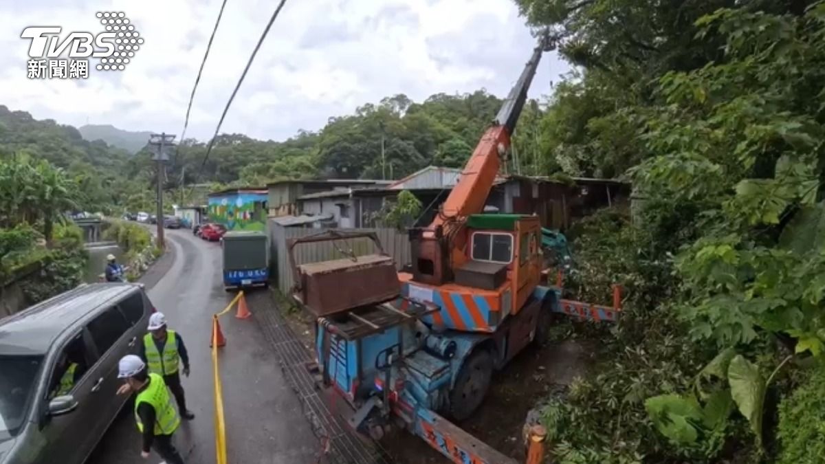 大雨不斷,南港舊莊街土石滑落約20米,工程人員鋸樹砍枝急搶救。(圖/TVBS)