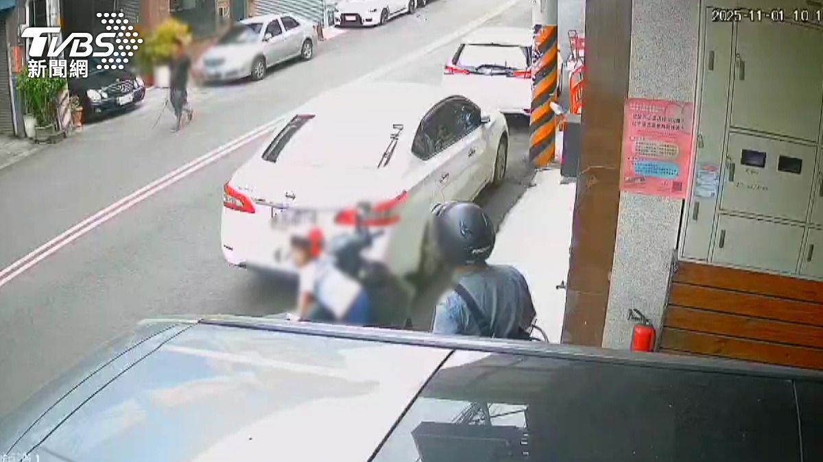 對面有人在砸車，感到害怕的她趕緊帶著孩子退回家中避難。(圖／TVBS)
