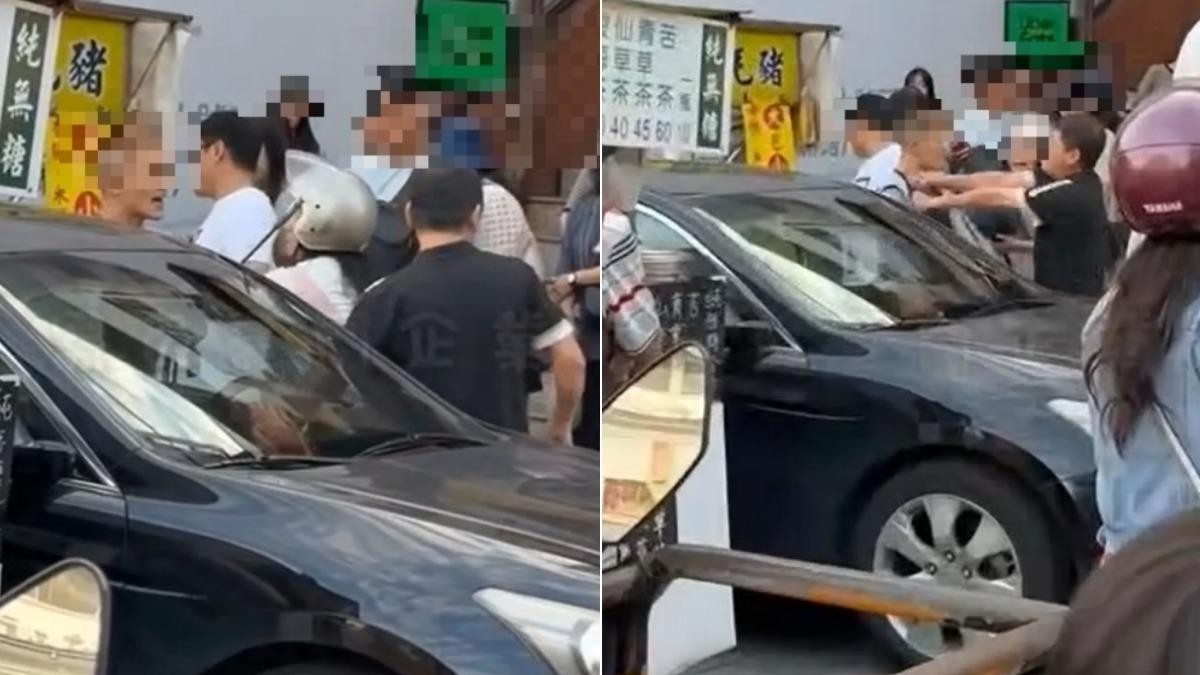 2名男子因行車糾紛當街爆發激烈口角，其中1人還持鐵棍作勢攻擊。（圖／翻攝黑色豪門企業）