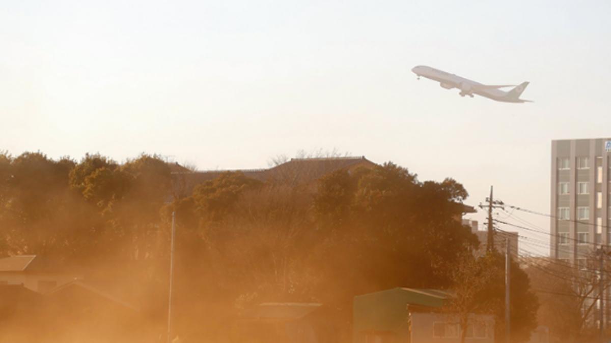一架飛機在成田機場附近起飛,強風捲起地面上的塵土。(圖/翻攝自千葉新聞)