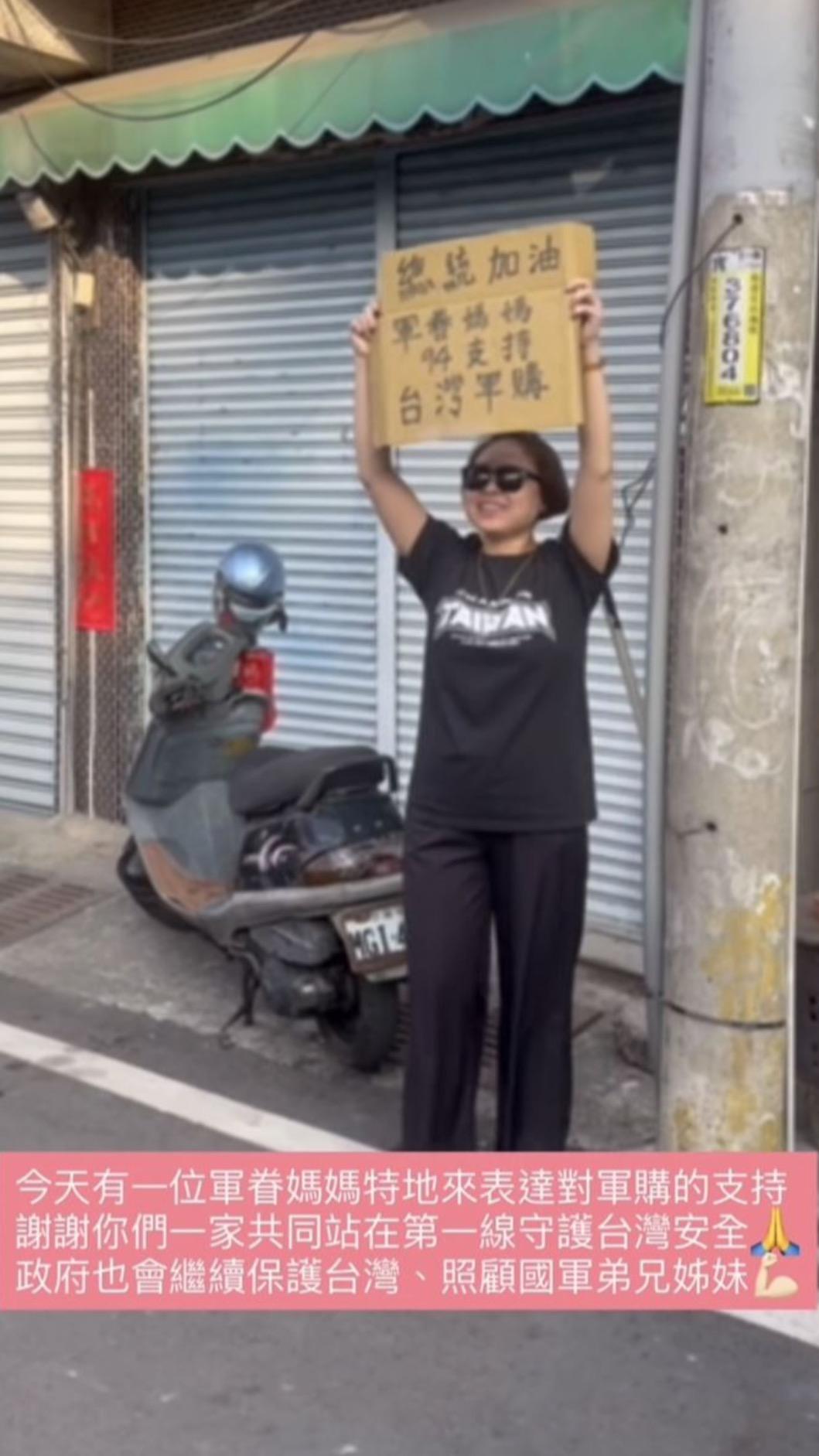 一名女子舉著「軍眷媽媽94支持台灣軍購」的紙板。(圖/翻攝自賴清德IG)