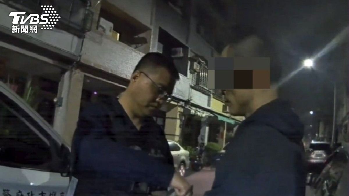 張男正大肆翻找路旁機車的置物箱被休假員警發現。（圖／TVBS）