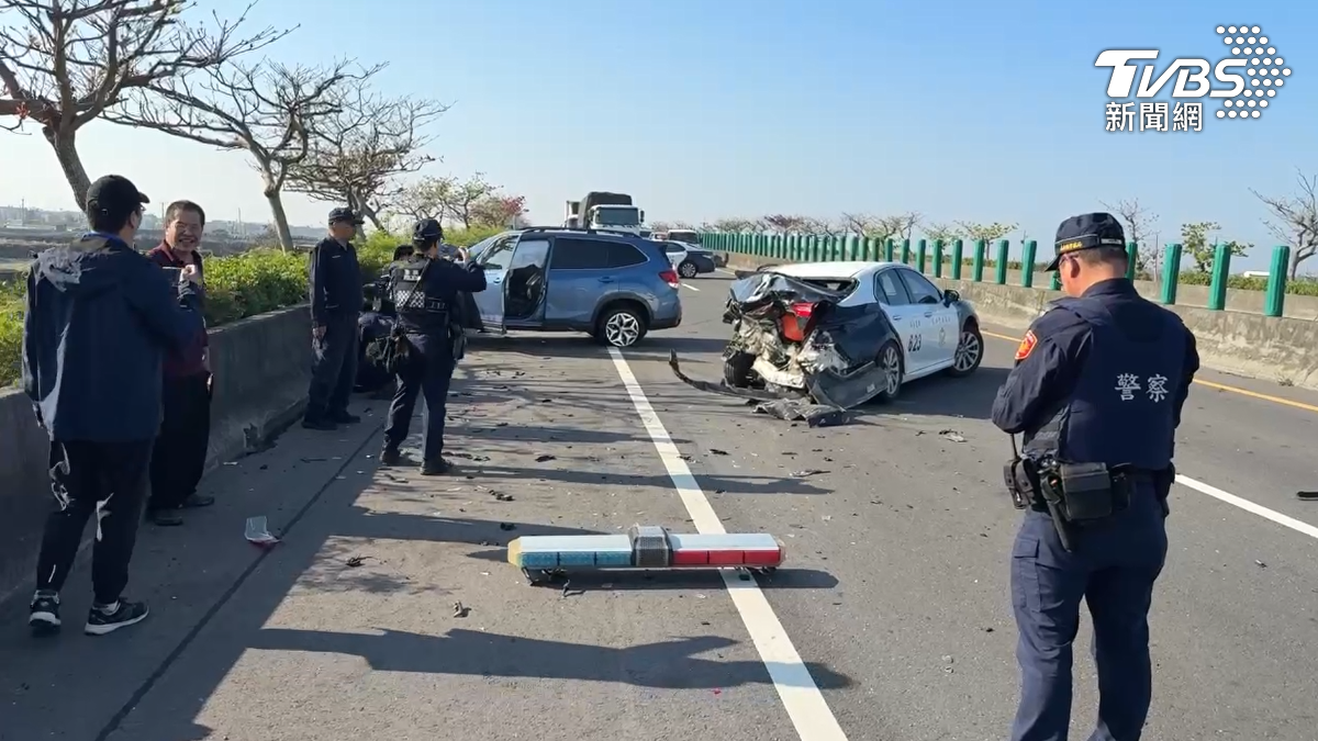 從現場畫面可見,警車車尾後車廂遭撞擊後嚴重凹陷,車輛零件四散一地,地上還有閃爍的警示燈。(圖/TVBS)