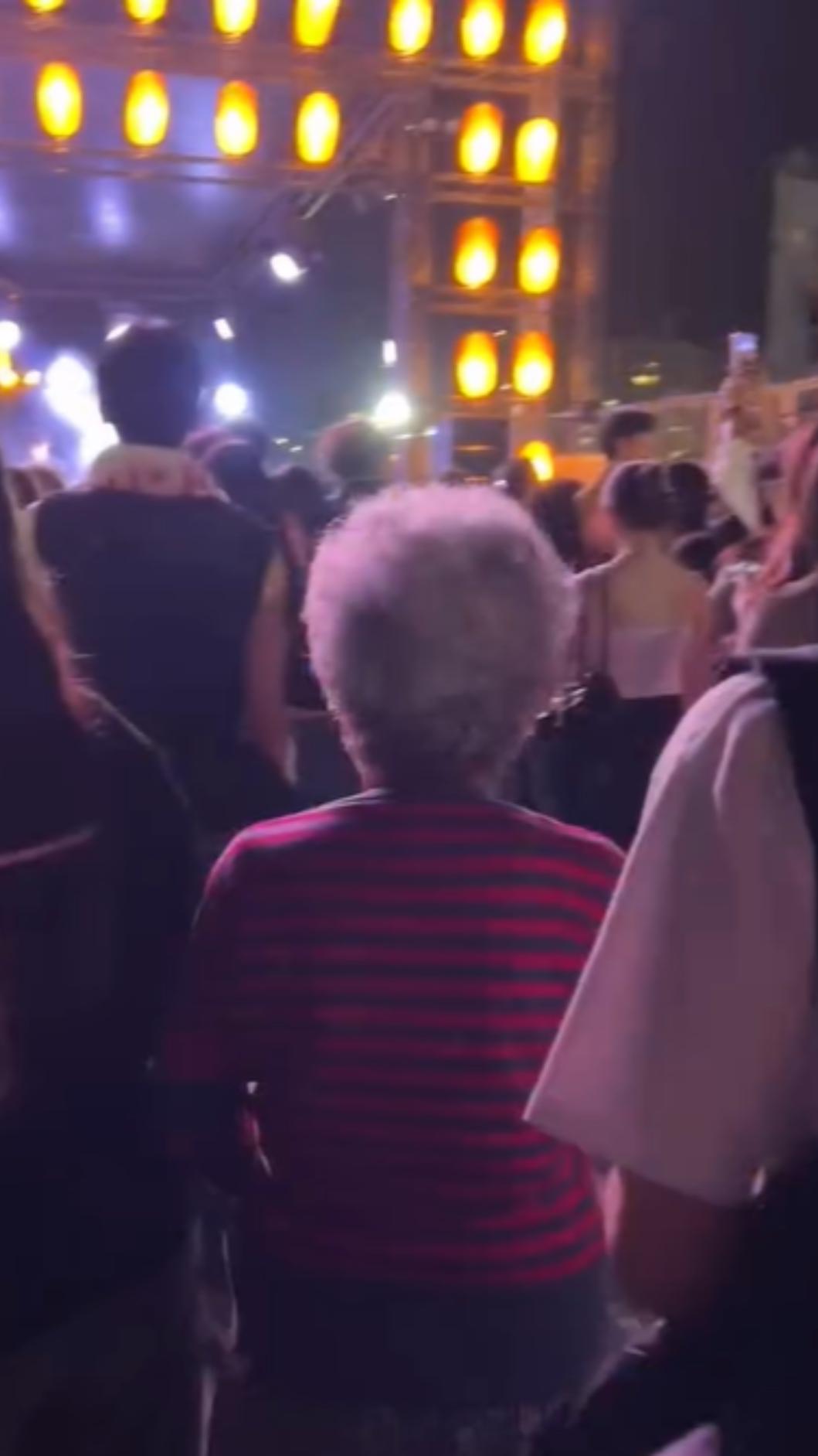 阿嬤拐著長傘越過人群,慢慢往舞台方向前進。(圖/Threads@kimi8.29授權提供)