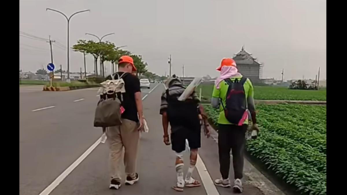 兩名網友陪步伐緩慢的「勇伯」走到北港朝天宮最後10公里。(圖/翻攝自臉書社團「白沙屯媽祖全球徒步聯誼會」)