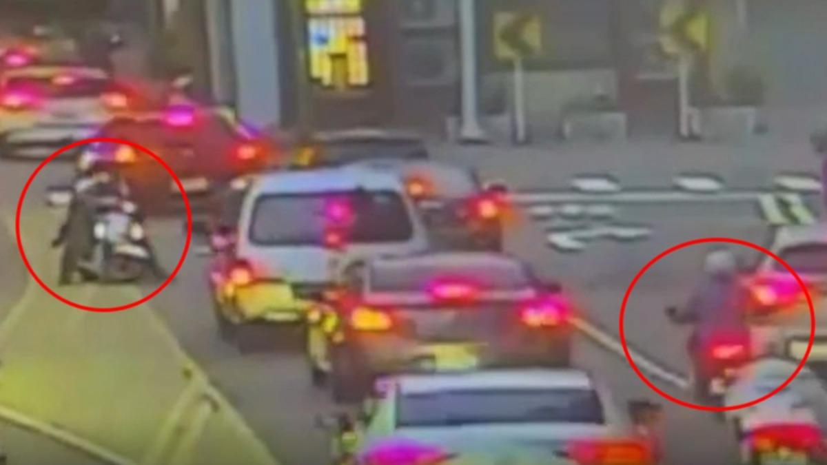 男子騎車載著小孩,卻違規跨越雙黃線,後方騎士看不下去上前卻因此爆發口角。(圖/TVBS)