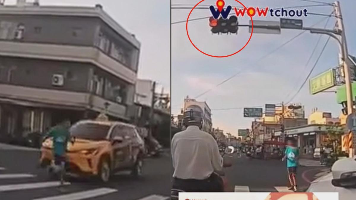 台南新市一輛計程車闖紅燈通過路口,差點撞上正在斑馬線上行走的男童。(圖/翻攝_WoWtchout-地圖型行車影像分享平台)