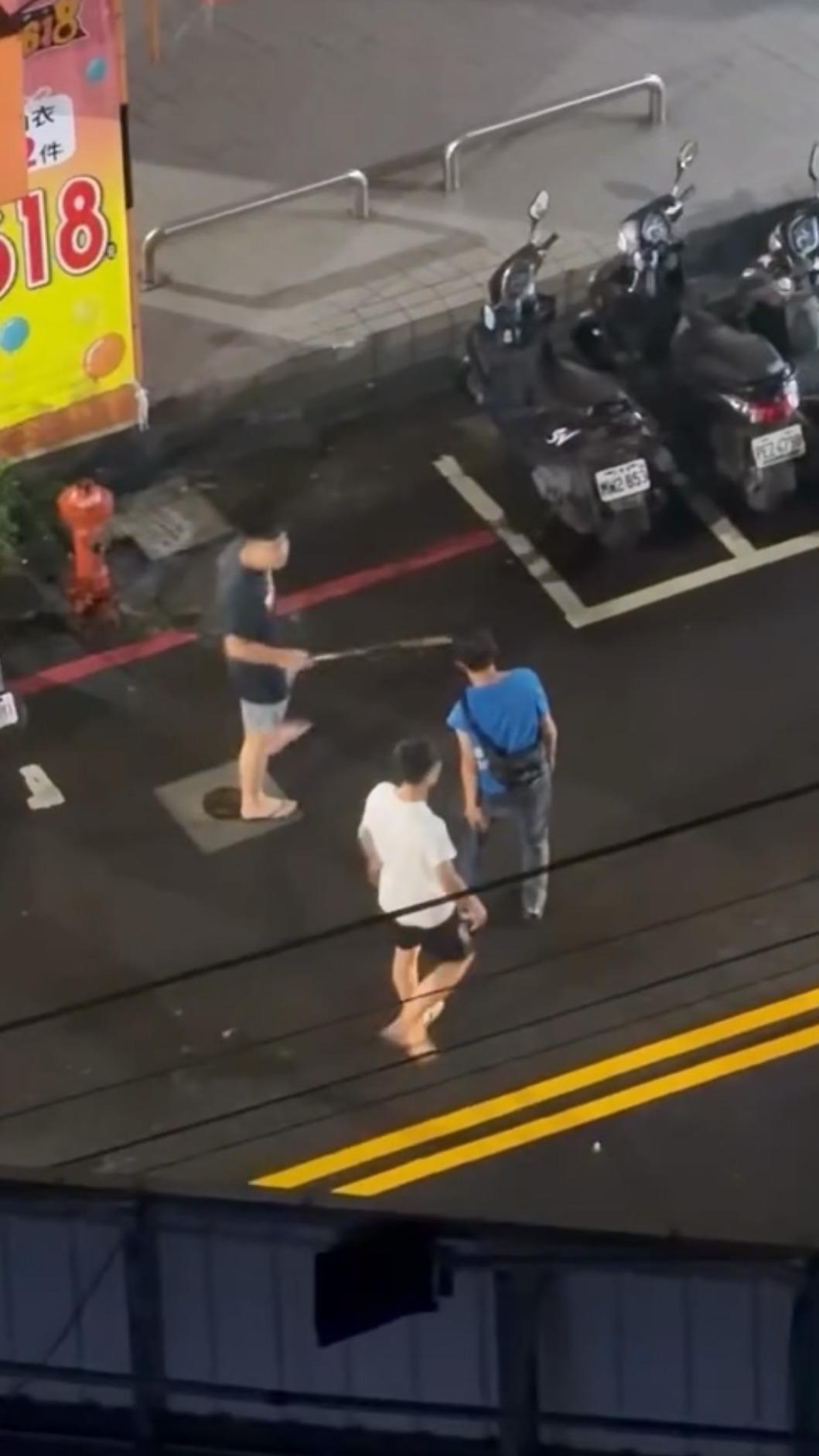 吳男（藍衣）左大腿遭許男（黑衣）以金屬傘架猛力揮擊。（圖／ji_1_1提供）