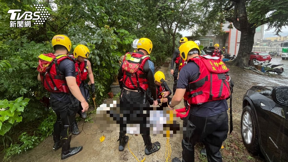 消防人員持續在受困車輛附近搜索，尋獲黃姓女子時已明顯死亡。（圖／TVBS）