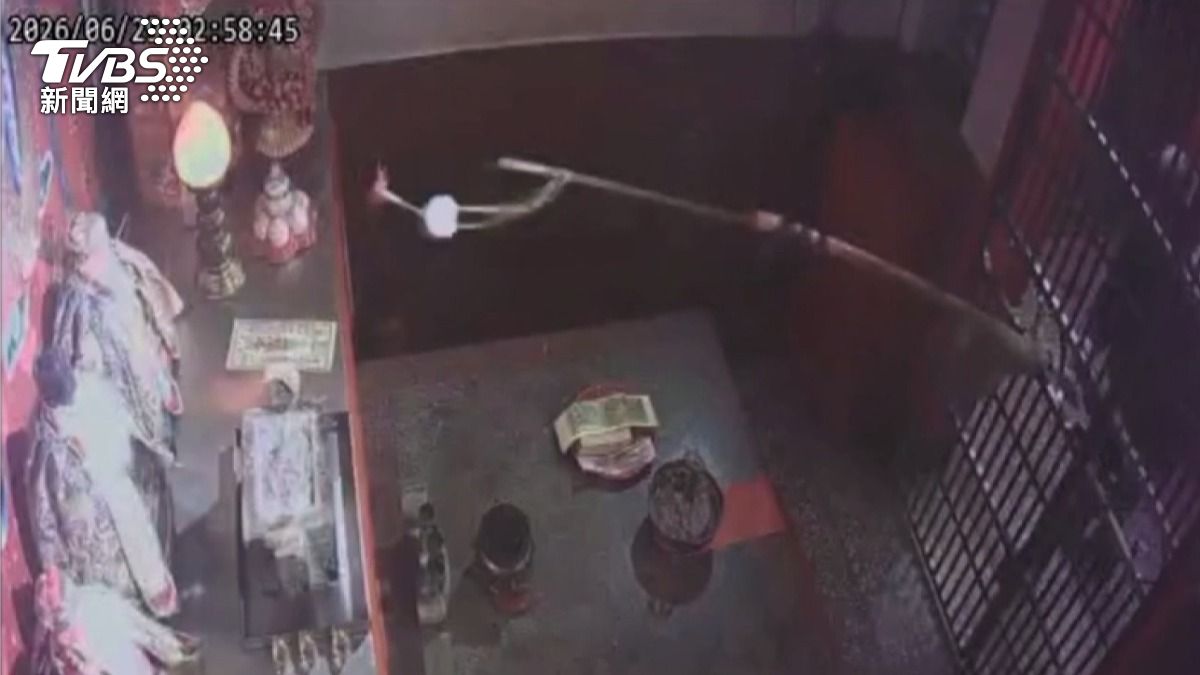 該名男子手持一根長木棍，勾住神像身上的金牌後，隨即將金牌取走離去。(圖／民眾提供)